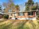 Charming brick home featuring a covered carport and a well-maintained front yard with mature trees at 4679 Bartlett Rd, Forest Park, GA 30297