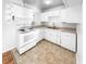 Well-lit kitchen with white cabinetry and appliances at 4679 Bartlett Rd, Forest Park, GA 30297
