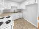 Well-lit kitchen with white cabinets, sleek countertops, and modern appliances at 4679 Bartlett Rd, Forest Park, GA 30297