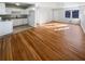 Bright living room featuring hardwood floors, neutral paint, and an adjoining kitchen at 4679 Bartlett Rd, Forest Park, GA 30297