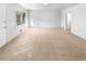 Bright living room offering plush carpet and freshly painted neutral walls at 4679 Bartlett Rd, Forest Park, GA 30297