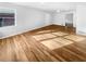 Bright, empty living room featuring hardwood floors and neutral paint at 4679 Bartlett Rd, Forest Park, GA 30297