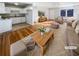Bright, staged living room featuring hardwood floors, neutral paint, and an adjoining kitchen at 4679 Bartlett Rd, Forest Park, GA 30297