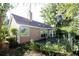 View of the backyard with a patio and a green lawn surrounded by mature trees at 672 Loral Pines Ct, Lawrenceville, GA 30044