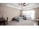 Cozy bedroom with a tray ceiling, neutral walls, large window and carpeted floors at 672 Loral Pines Ct, Lawrenceville, GA 30044