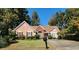 Charming one-story house with landscaped yard, a long driveway, and mature trees at 672 Loral Pines Ct, Lawrenceville, GA 30044