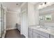 Bright bathroom featuring a double vanity with granite countertops, a glass shower, and neutral paint at 765 Hembree Rd, Alpharetta, GA 30076