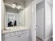 Bathroom featuring a white vanity with a large mirror and views into an adjacent bedroom at 765 Hembree Rd, Alpharetta, GA 30076