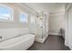 Serene bathroom with a standalone tub, a glass enclosed shower, and neutral color palette at 765 Hembree Rd, Alpharetta, GA 30076