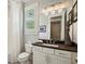 Cozy bathroom with patterned floor, white cabinets, framed mirror, and shower/tub at 765 Hembree Rd, Alpharetta, GA 30076