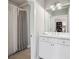 Bathroom featuring a white vanity with a large mirror and views into an adjacent room with shower at 765 Hembree Rd, Alpharetta, GA 30076