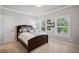 Bedroom with a dark wooden bed frame, neutral walls, and lots of natural light at 765 Hembree Rd, Alpharetta, GA 30076