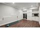 Bonus room with a golf training setup and stairs along with custom storage, and built-in cabinets and shelves at 765 Hembree Rd, Alpharetta, GA 30076