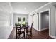 Charming dining area featuring hardwood floors, shiplap accents, a sliding barn door, and backyard views at 765 Hembree Rd, Alpharetta, GA 30076