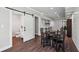 Dining area with a view of the modern bathroom with a barn door and white countertop with backsplash at 765 Hembree Rd, Alpharetta, GA 30076