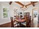 Elegant dining room featuring a chandelier, wood beams, and a staircase view at 765 Hembree Rd, Alpharetta, GA 30076