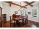 Formal dining room with decorative ceiling beams, a chandelier, and a wine fridge at 765 Hembree Rd, Alpharetta, GA 30076