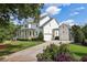Charming two-story white home with well-manicured landscaping and a welcoming front porch at 765 Hembree Rd, Alpharetta, GA 30076