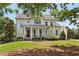 Beautiful two-story home with a welcoming front porch and lush landscaping at 765 Hembree Rd, Alpharetta, GA 30076