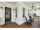 Inviting front porch with rocking chairs and stylish lighting fixtures at 765 Hembree Rd, Alpharetta, GA 30076