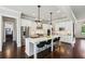 Open-concept kitchen with a large island, stainless steel appliances, and hardwood flooring at 765 Hembree Rd, Alpharetta, GA 30076