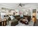 Open-concept living room with a kitchen view, large sofa, and a staircase at 765 Hembree Rd, Alpharetta, GA 30076