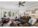 Spacious living room with large windows, comfortable seating, and a kitchen view at 765 Hembree Rd, Alpharetta, GA 30076