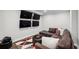 Comfortable living room featuring a sectional sofa, an ottoman, accent rug, and multiple wall-mounted television screens at 765 Hembree Rd, Alpharetta, GA 30076