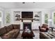 Living room with shiplap wall, fireplace, built-in shelves, and a cozy seating arrangement at 765 Hembree Rd, Alpharetta, GA 30076