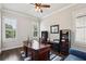 Well-lit home office with hardwood flooring, ceiling fan, and built-in shelving at 765 Hembree Rd, Alpharetta, GA 30076