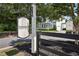 Welcoming entrance with prominent 'Hembree' sign and view of the beautiful white farmhouse at 765 Hembree Rd, Alpharetta, GA 30076
