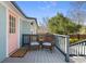 Back deck with wicker chairs and pink door to enter the house at 28 Peachtree Hills Ne Ave, Atlanta, GA 30305