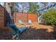 Serene backyard space features a fire pit, lounge seating and privacy fencing for relaxation and entertaining at 28 Peachtree Hills Ne Ave, Atlanta, GA 30305