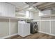 Basement laundry area with washer, dryer, and overhead cabinets at 28 Peachtree Hills Ne Ave, Atlanta, GA 30305