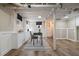 Finished basement space with exposed pipes, painted white brick, and wood-look flooring at 28 Peachtree Hills Ne Ave, Atlanta, GA 30305