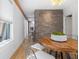 Dining area with wood table, stone accent wall, and natural light from nearby windows at 28 Peachtree Hills Ne Ave, Atlanta, GA 30305