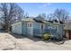 Charming blue home features a cute deck, complemented by a concrete driveway and landscaped surroundings at 28 Peachtree Hills Ne Ave, Atlanta, GA 30305