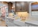 Charming kitchen sink area with unique tile backsplash, stone countertops and farmhouse style sink at 28 Peachtree Hills Ne Ave, Atlanta, GA 30305