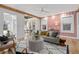 Well-lit living room with pink accent wall and sunroom view offers a stylish and relaxing atmosphere at 28 Peachtree Hills Ne Ave, Atlanta, GA 30305