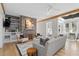 Bright and airy living room with stone fireplace, wooden beams, and sunroom access creates a warm atmosphere at 28 Peachtree Hills Ne Ave, Atlanta, GA 30305