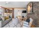 Bright living room featuring a stone fireplace, plush seating, and open access to the kitchen at 28 Peachtree Hills Ne Ave, Atlanta, GA 30305