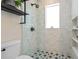 Shower featuring built-in shelving and decorative floor tiles at 28 Peachtree Hills Ne Ave, Atlanta, GA 30305