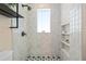 Shower featuring built-in shelving and decorative floor tiles at 28 Peachtree Hills Ne Ave, Atlanta, GA 30305