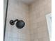 Close-up of a black shower head against white tiled walls in an updated bathroom at 28 Peachtree Hills Ne Ave, Atlanta, GA 30305