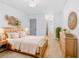 Bedroom featuring light wood floors, a wood bed frame, and modern decor with bathroom in the background at 3527 Essex Ave # 74, Atlanta, GA 30339