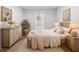 Bedroom with a wooden bed frame, natural light, light-colored walls, and side tables at 3527 Essex Ave # 74, Atlanta, GA 30339