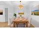 Elegant dining room with a wood table set for six and decorative light fixture at 3527 Essex Ave # 74, Atlanta, GA 30339