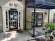 Building entrance featuring black frame doors and windows, decorative pediment, and concrete walkway at 3527 Essex Ave # 74, Atlanta, GA 30339