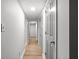 Hallway with light wood flooring and neutral paint, leading to additional rooms with closet space at 3527 Essex Ave # 74, Atlanta, GA 30339