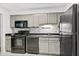 Functional kitchen with black appliances, grey cabinets, and ample counter space at 3527 Essex Ave # 74, Atlanta, GA 30339